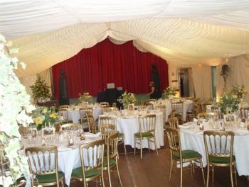 Wedding, using a marquee lining and hired-in chairs and tables.